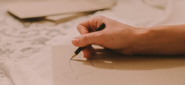 Person sketching on paper